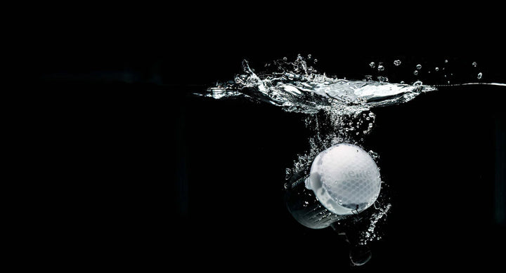 Strobe splashing into water on a black background